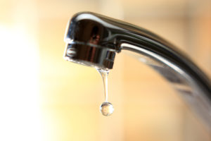 Leaking bathroom faucet causing water waste and higher utility bills.