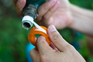 man repair water pipe with seal Tape