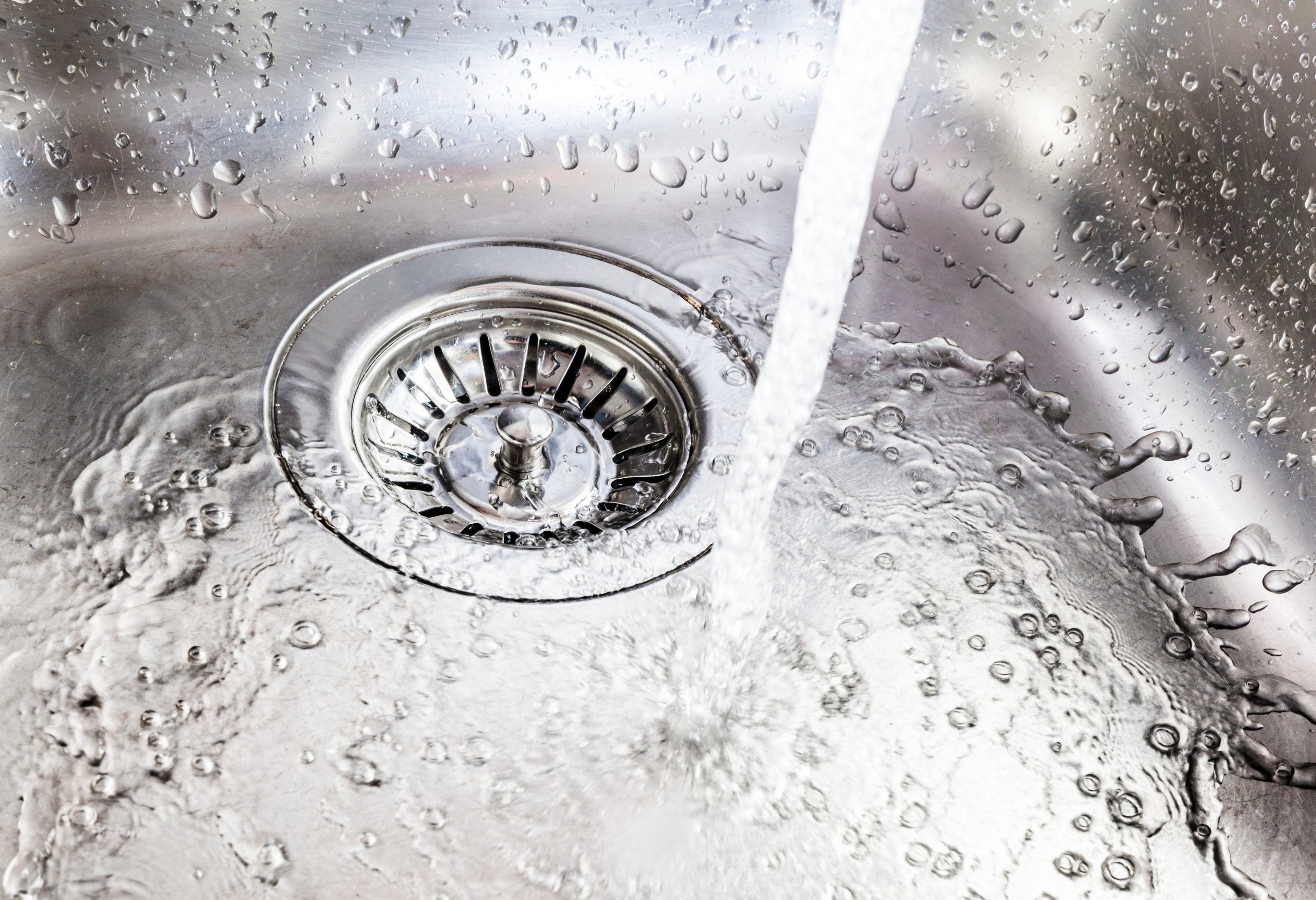 Professional plumber cleaning a clogged drain in Santa Rosa