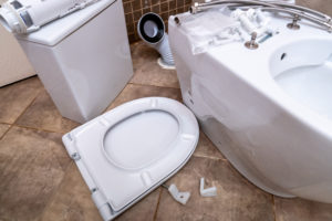 Plumber inspecting a toilet to determine its lifespan in Santa Rosa, CA.