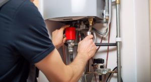 Plumber inspecting a hot water heater for repairs in Santa Rosa, CA.